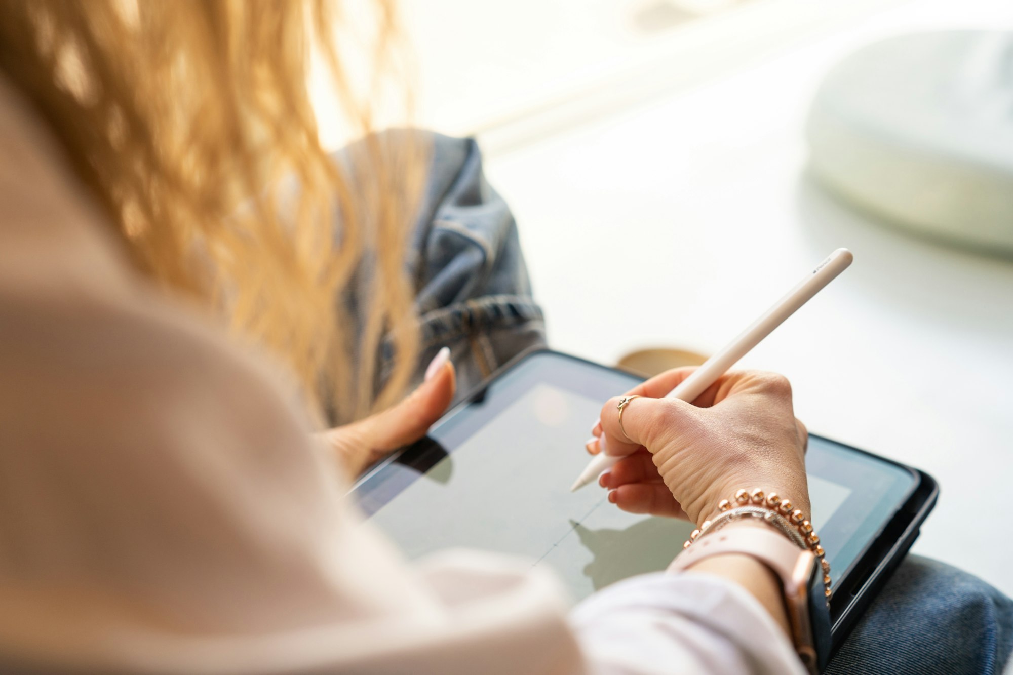 illustrator working on her tablet in the cafe